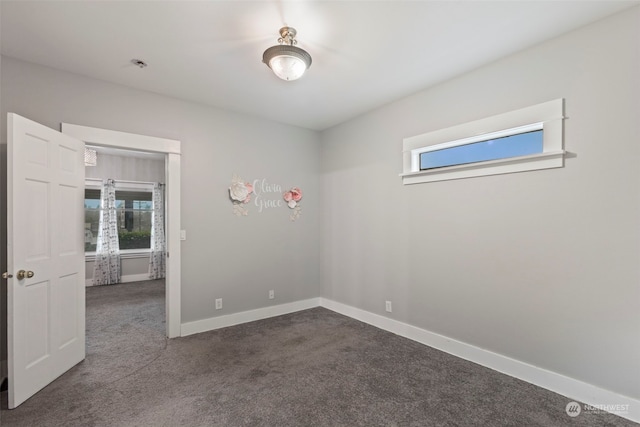 carpeted empty room with plenty of natural light