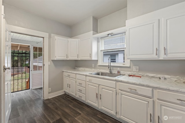 kitchen featuring sink, white cabinets, light stone counters, and dark hardwood / wood-style flooring