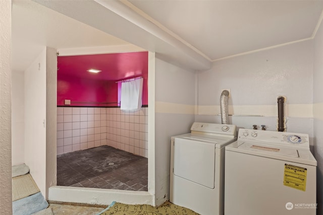 laundry area featuring washer and dryer and tile walls