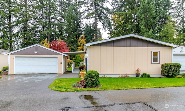 view of side of property with a garage, an outdoor structure, and a yard