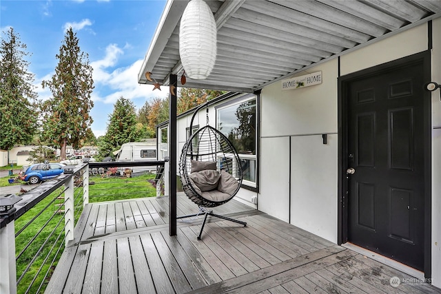 wooden terrace featuring a yard