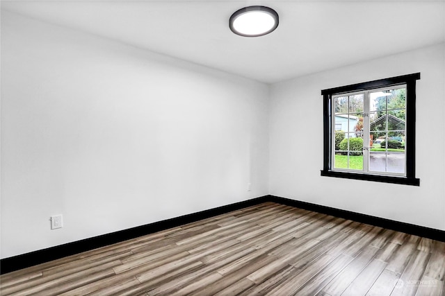 empty room with light hardwood / wood-style flooring