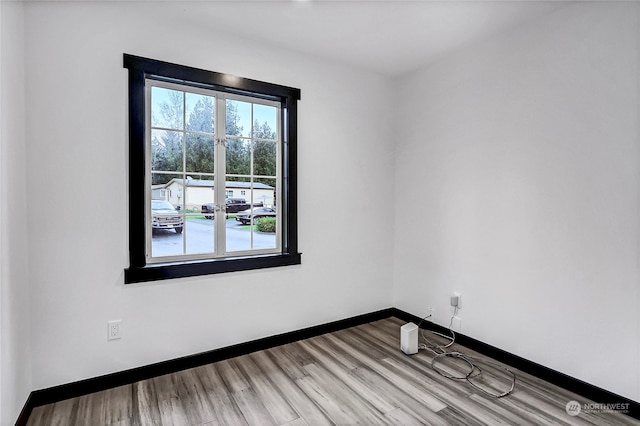 unfurnished room with light wood-type flooring