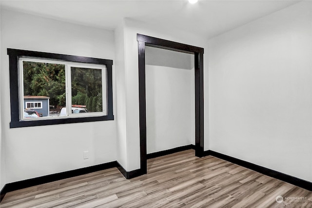 unfurnished room with light wood-type flooring