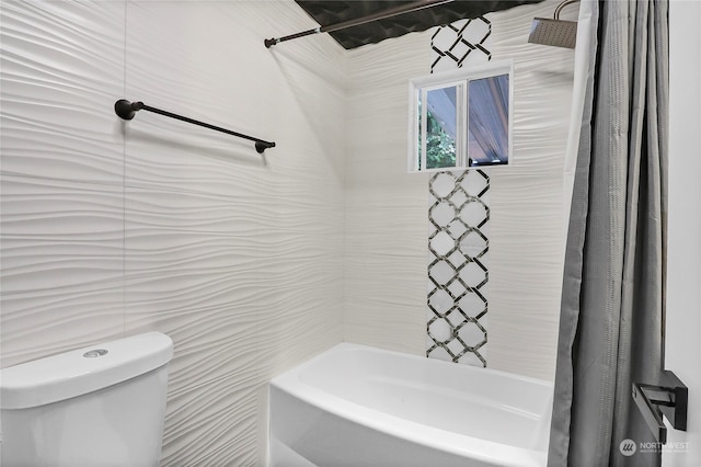 bathroom featuring shower / bath combination with curtain, toilet, and tile walls