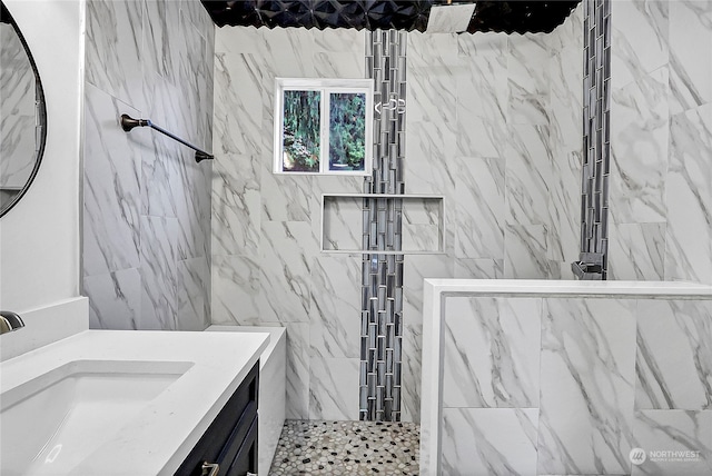 bathroom with vanity and tiled shower