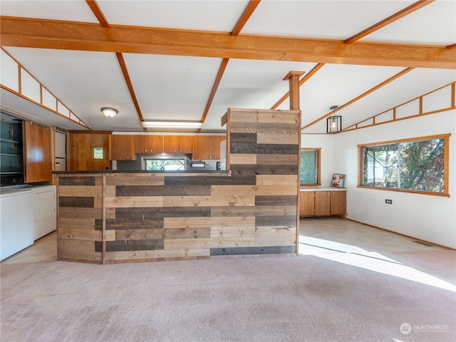 living room with light carpet, independent washer and dryer, and vaulted ceiling with beams