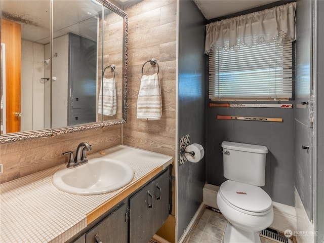 bathroom with vanity, toilet, and tile patterned floors