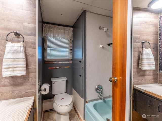 full bathroom with wood walls, separate shower and tub, toilet, tile patterned floors, and vanity