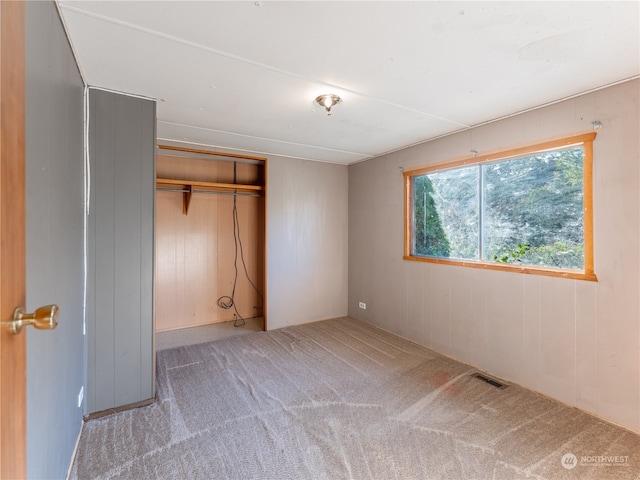 unfurnished bedroom with a closet and carpet