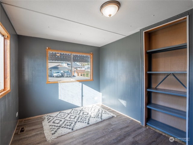 interior space featuring wooden walls and wood-type flooring