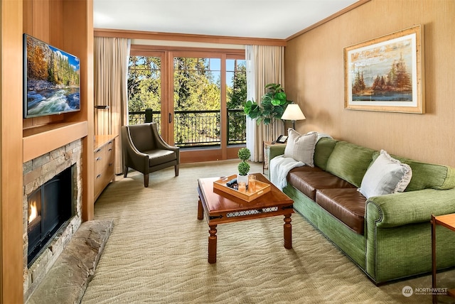 carpeted living room featuring ornamental molding and a fireplace