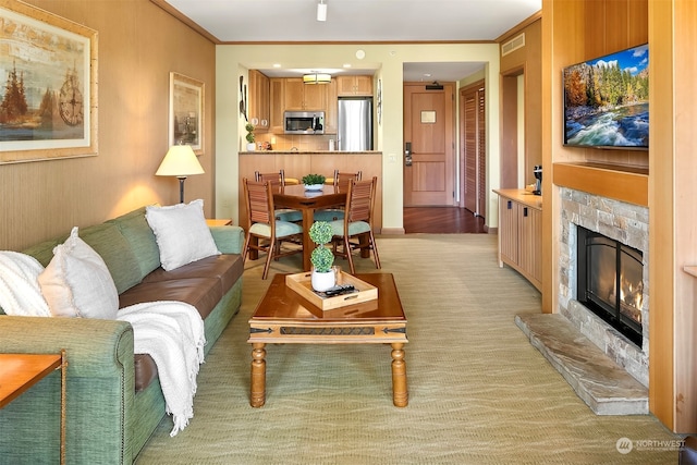 living room with crown molding and a fireplace