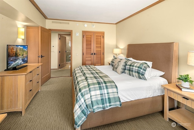 carpeted bedroom featuring crown molding and a closet