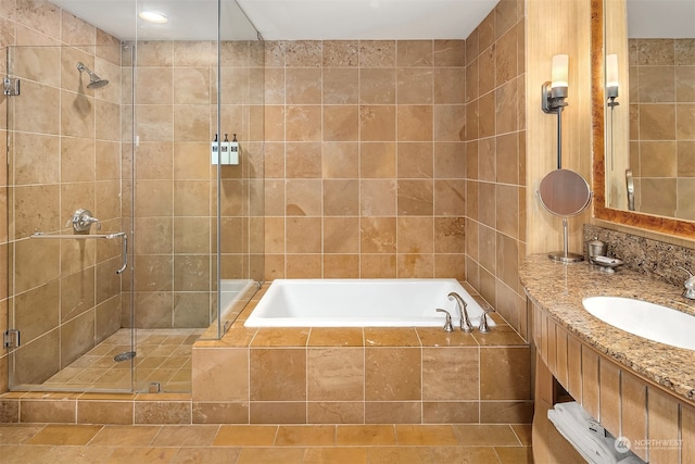 bathroom featuring vanity and separate shower and tub