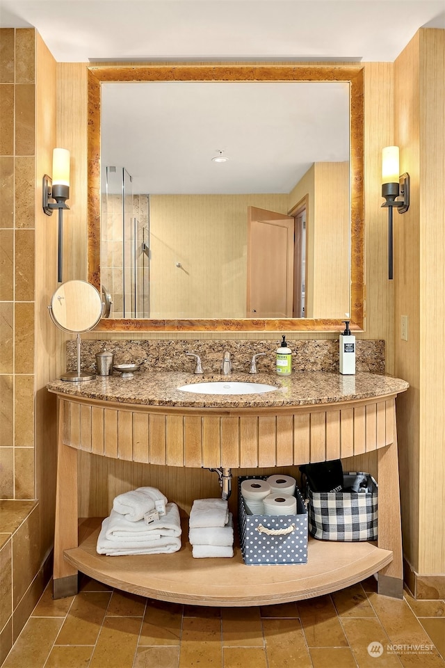 bathroom featuring walk in shower and sink