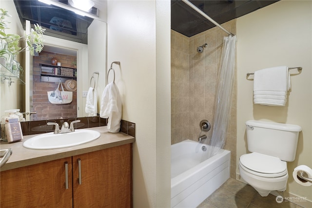 full bathroom featuring vanity, shower / bath combo with shower curtain, toilet, and tile patterned flooring