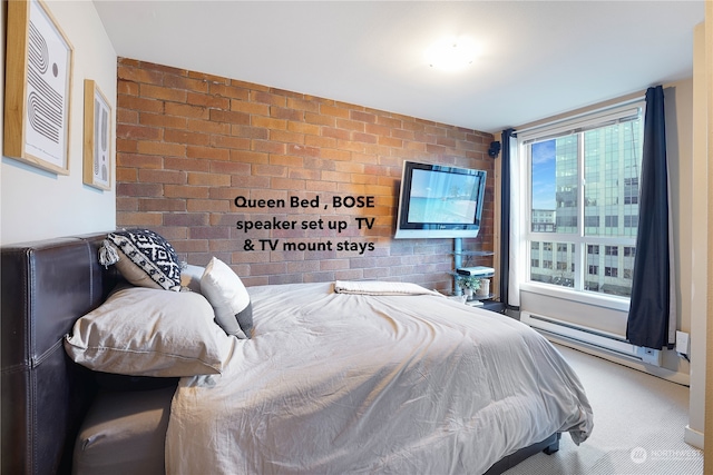 carpeted bedroom featuring brick wall and a baseboard heating unit