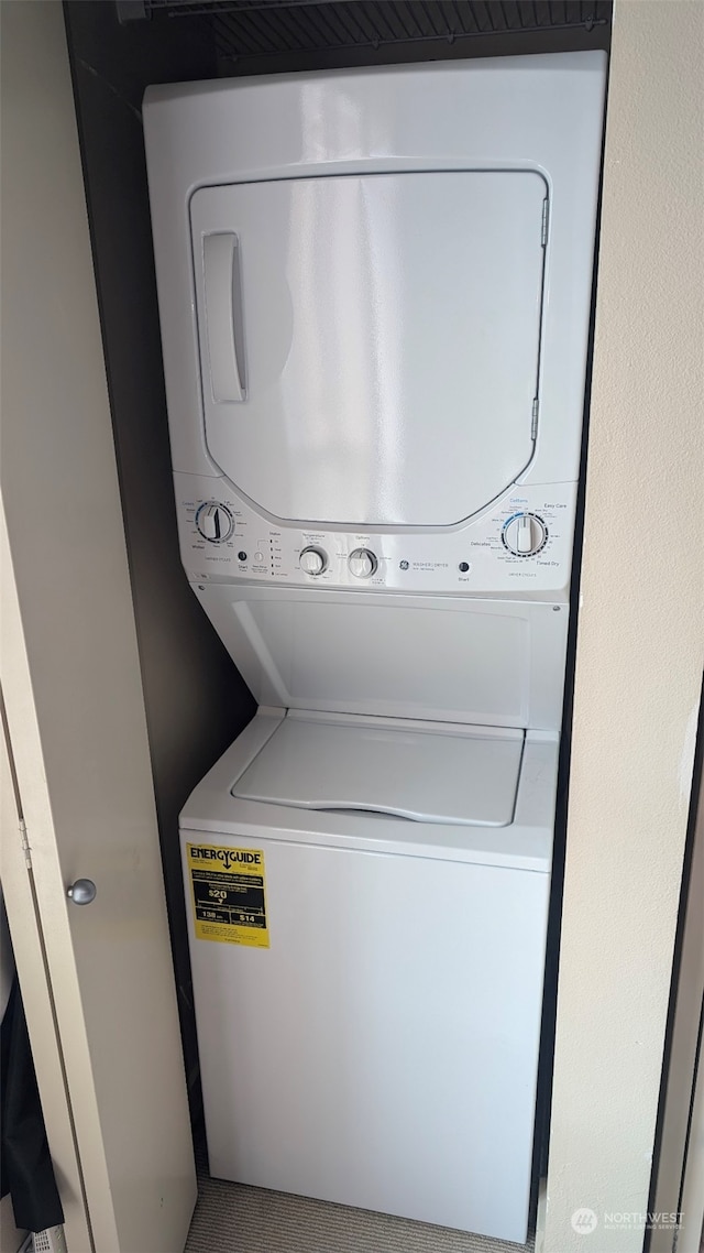 laundry area with stacked washing maching and dryer