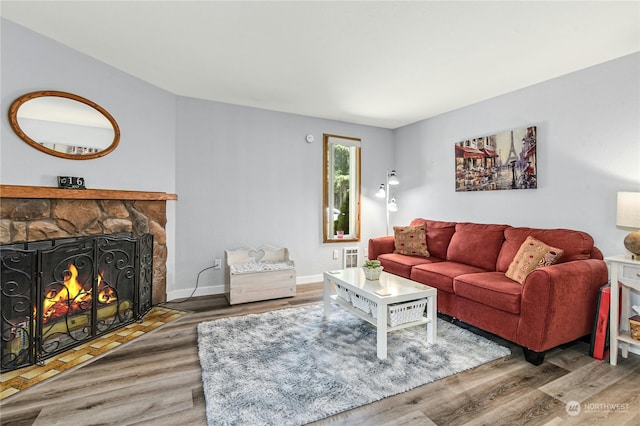 living room with hardwood / wood-style flooring and a fireplace