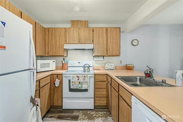 kitchen featuring white appliances, a textured ceiling, dark wood-type flooring, and sink