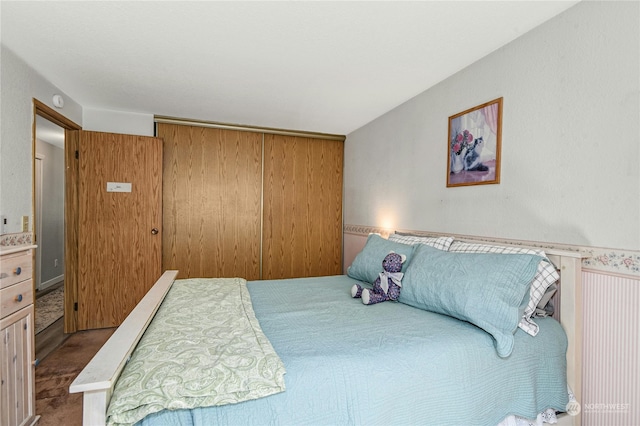 carpeted bedroom featuring wooden walls