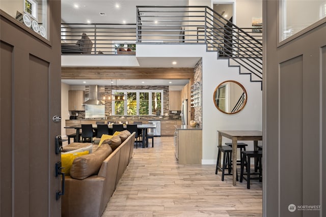 entryway featuring a high ceiling and light hardwood / wood-style floors