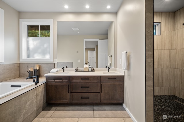 bathroom featuring vanity, shower with separate bathtub, and tile patterned flooring