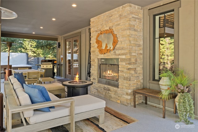 view of patio / terrace with area for grilling and an outdoor stone fireplace