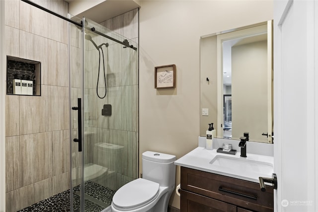 bathroom with vanity, toilet, and an enclosed shower