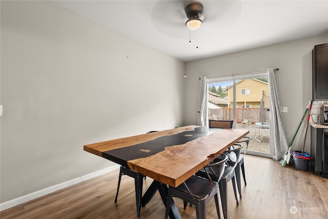 dining space with light hardwood / wood-style flooring and ceiling fan