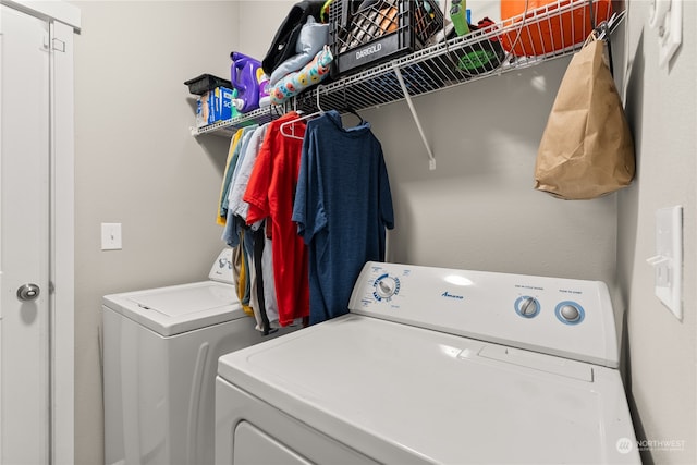 clothes washing area featuring washer and dryer