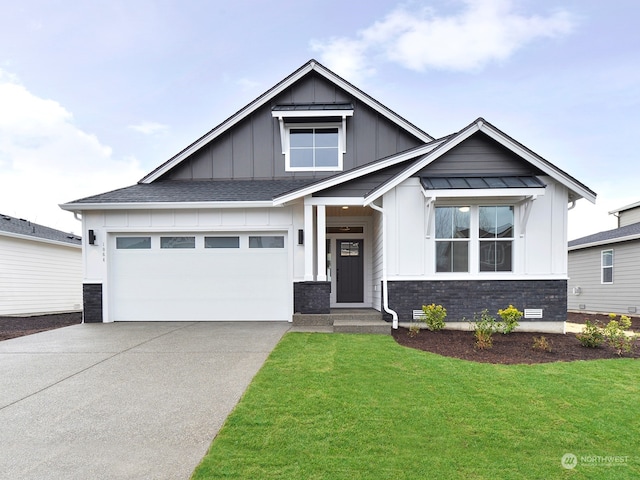 view of front of property featuring a garage and a front lawn