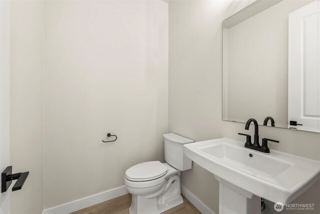 6361LOT257 Great Glen Rd SW, Port Orchard, WA 98367 - half bath featuring toilet, baseboards, a sink, and wood finished floors