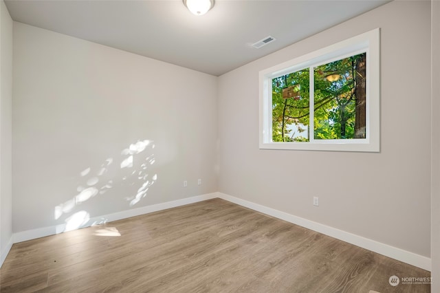 unfurnished room with light hardwood / wood-style floors