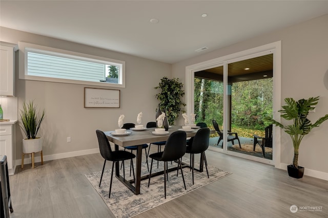 dining space featuring a wealth of natural light and light wood-type flooring