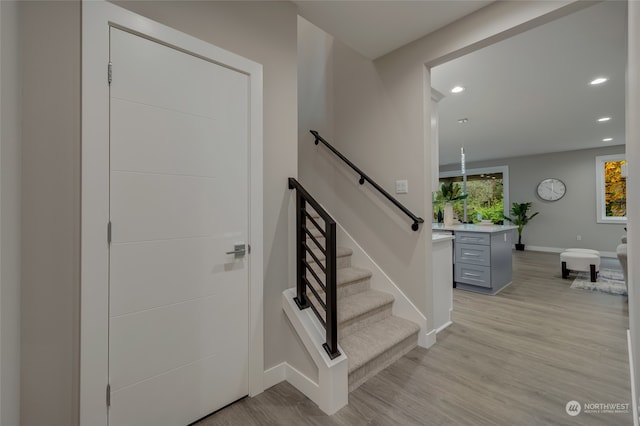 stairs with hardwood / wood-style flooring