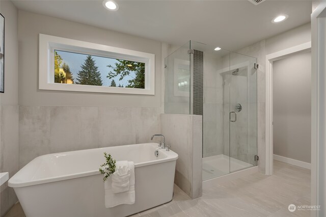 bathroom with separate shower and tub