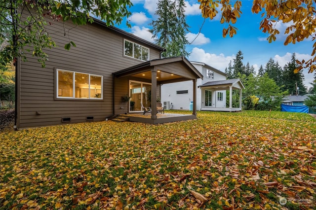 rear view of property featuring a patio and a deck