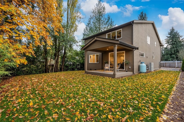 back of house featuring a patio, a yard, and central air condition unit