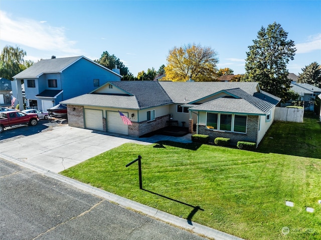 single story home with a garage and a front lawn