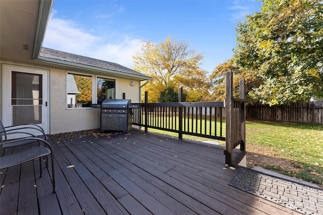 wooden terrace featuring area for grilling and a lawn