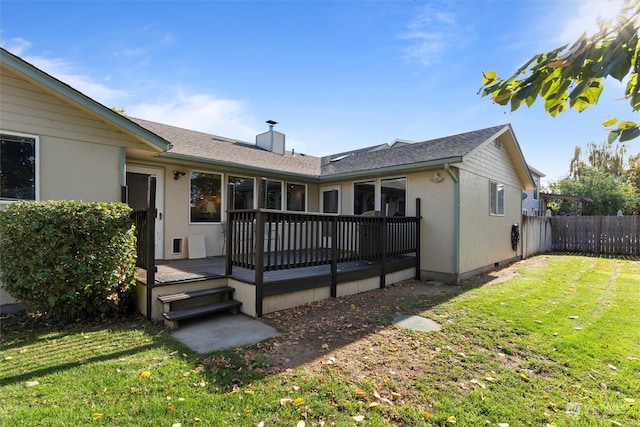 back of property featuring a lawn and a deck