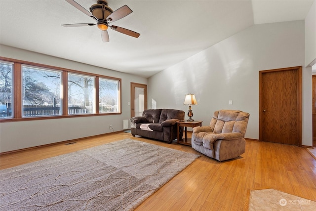 living room with lofted ceiling, hardwood / wood-style flooring, plenty of natural light, and ceiling fan