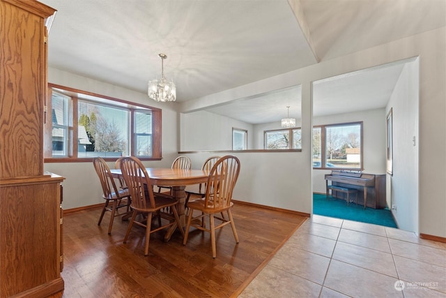 dining space featuring an inviting chandelier and light hardwood / wood-style flooring