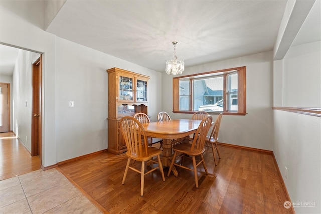 dining area featuring an inviting chandelier and light hardwood / wood-style floors