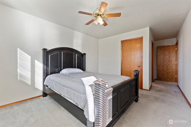 bedroom featuring light colored carpet and ceiling fan