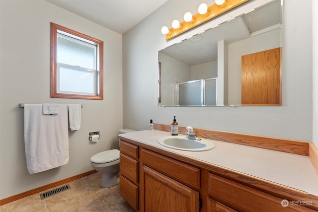 bathroom with vanity, an enclosed shower, and toilet