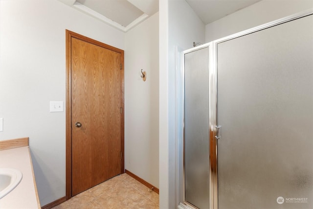 bathroom with vanity, tile patterned floors, and walk in shower