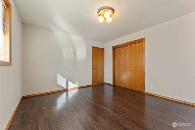 unfurnished room with dark hardwood / wood-style flooring